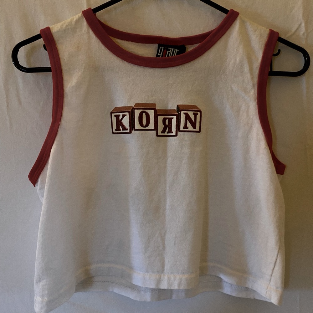 White crop top loose fit with red outline.
